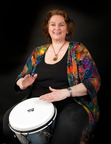 Susie Hurley playing a djembe drum